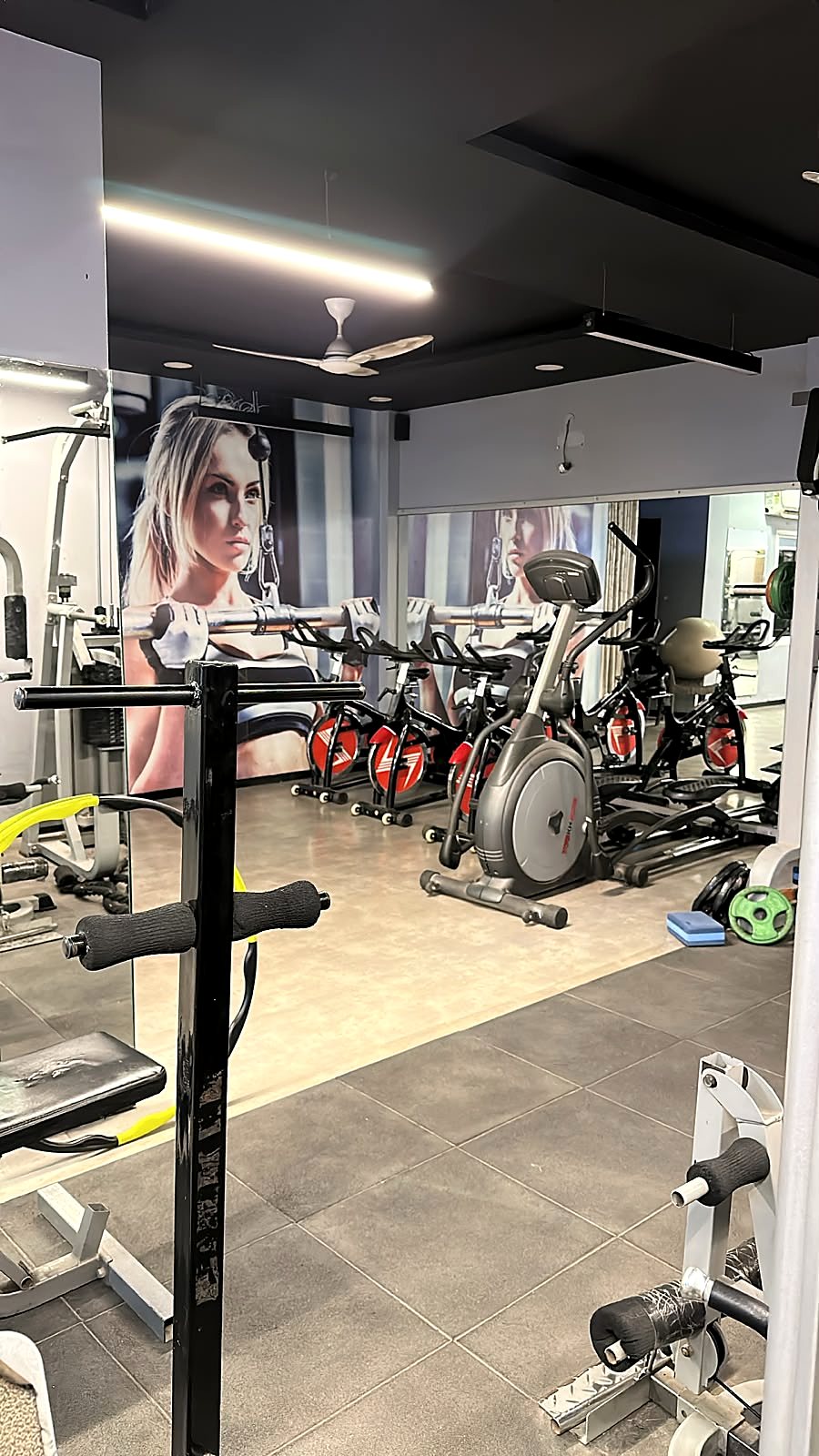 Cardio zone with spin bikes and an elliptical cross-trainer